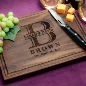 personalized gift for newlyweds with initial on a walnut cutting board