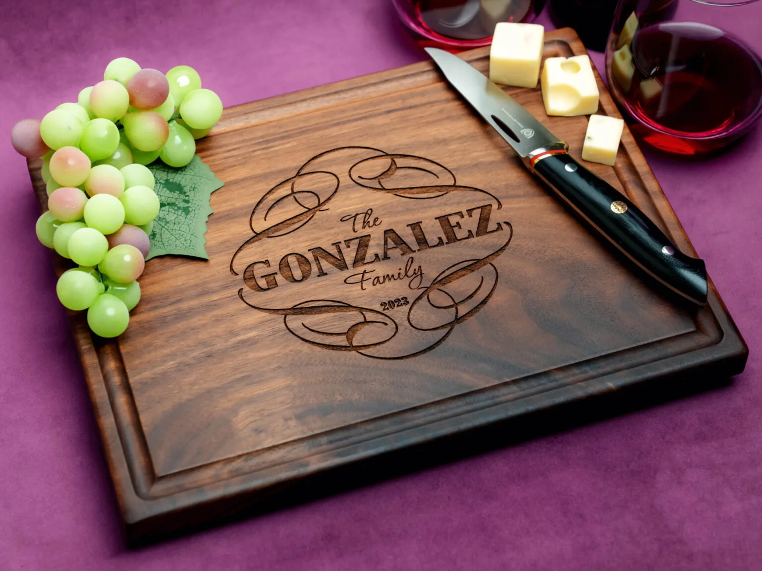 custom walnut charcuterie board with cheese green grapes and red wine