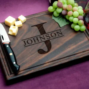custom engraved walnut charcuterie board with grapes cheese knife and red wine