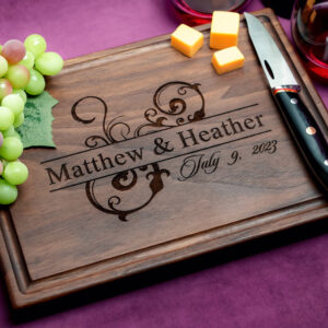 personalized natural hardwood board with green grapes two glasses of red wine cheese knife