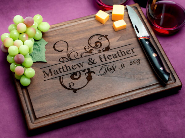 personalized natural hardwood board with green grapes two glasses of red wine cheese knife