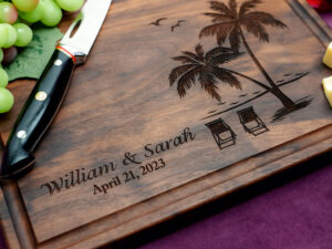 Walnut cutting board engraved with tropical beach view with couples' first names and date