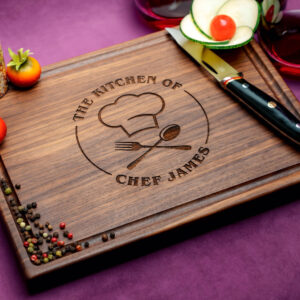 walnut charcuterie board with spices little tomatoes cucumber and knife on purple background