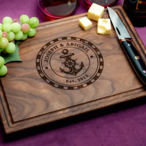 walnut charcuterie board with cheeses green grapes cheese knife and two glasses on red wine on purple background