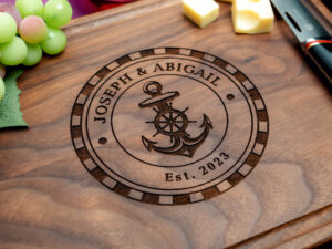 walnut board engraved with anchor design with first names of couple and wedding date