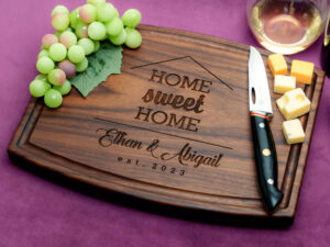 personalized charcuterie board with cheese green grapes and glass of white wine