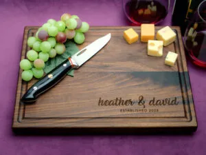 personalized cutting board with right bottom corner engraving on purple background