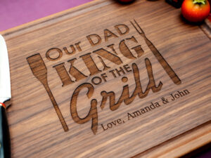 wooden cutting board featuring the phrase "Dad, King of the Grill" perfect for barbecue enthusiasts and proud fathers