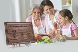 Handcrafted walnut cutting board adorned with Family members Design and personalized details. Encircling the board, a family joyfully prepares a meal, creating cherished memories in their bustling kitchen atmosphere.