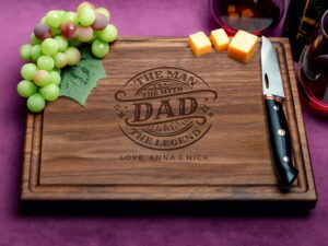 This walnut custom cutting board with a juice groove is accompanied with 'DAD: The Man, The Myth, The Legend' design in stylish engraving, making it an impeccable choice for honoring Dad with a thoughtful and practical gift.