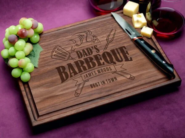 Discover the perfect gift for Dad with our personalized walnut cutting board featuring a distinctive 'Dad's Barbeque Best In Town' design and a practical juice groove. Designed to withstand daily use, it combines functionality with sentimental value, making it an excellent choice for Father's Day or special occasions. The rich walnut wood not only enhances its aesthetics but also offers inherent antimicrobial benefits, ensuring a safe and stylish addition to any kitchen. Whether slicing or serving, this board promises to delight any culinary enthusiast.