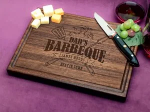 Elevate Dad's cooking experience with our custom walnut cutting board, detailed with a 'Dad's Barbeque Best In Town' motif and a functional juice groove. Crafted for durability and charm, it's a thoughtful gift for Father's Day and beyond. Its premium walnut wood not only adds a touch of elegance but also boasts natural antibacterial properties, ensuring a hygienic kitchen environment. Ideal for showcasing culinary skills or as a memorable keepsake, this board is a versatile addition to any home chef's toolkit.