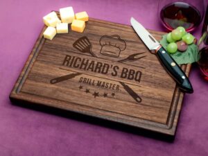 Make a statement with our personalized walnut cutting board, showcasing a Grill Master design and practical juice groove. Crafted from premium walnut wood, it combines durability with aesthetic appeal, making it an ideal gift for various occasions. Its natural antibacterial properties enhance kitchen hygiene, while the personalized touch adds sentimentality. Perfect for BBQ enthusiasts or as a memorable present, this board exemplifies versatility and quality craftsmanship.