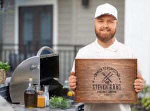 Transform your BBQ gatherings with our personalized walnut cutting board, featuring a 'Grilling & Chilling Design'. Displayed by a dad amidst a backyard grilling scene, complete with all accessories, this board's juice groove adds practicality and charm, making it the perfect Father's Day gift.