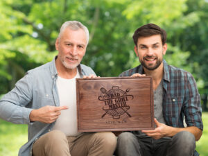 Father and son showing personalized cutting board gift