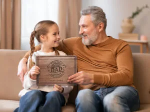 Daughter is giving to dad personalized cutting board gift for father's day