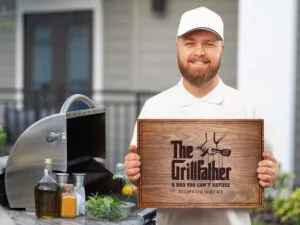 Happy dad showing personalized gift engraved cutting board with Grill father design