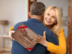 Happy woman holding engraved cutting board with officially retired design