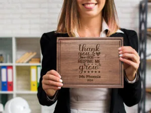 Daycare teacher holding appreciation gift personalized cutting board