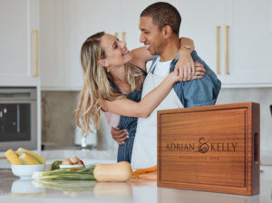 happy married couple cooking in a kitchen using mahogany chopping block for bbq