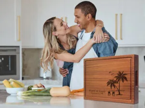 happy couple cooking in a kitchen using mahogany chopping block for soup