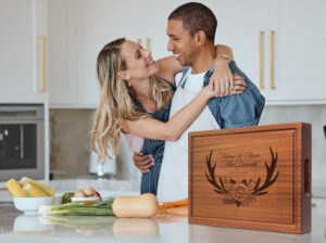 happy couple cooking in a kitchen using mahogany chopping block for food prep