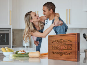 happy couple cooking in the kitchen using hardwood mahogany chopping block for food prep
