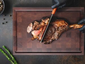 chopping steak on mahogany end grain chopping block