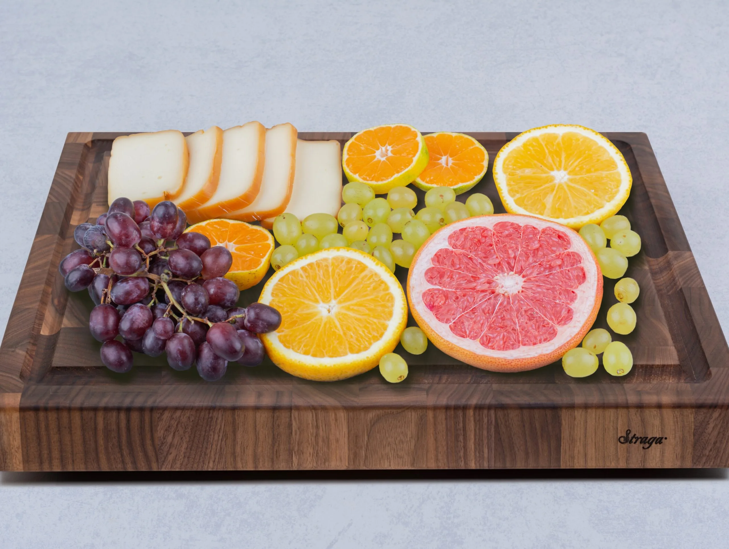 charcuterie fruits and cheese served on walnut end grain chopping block